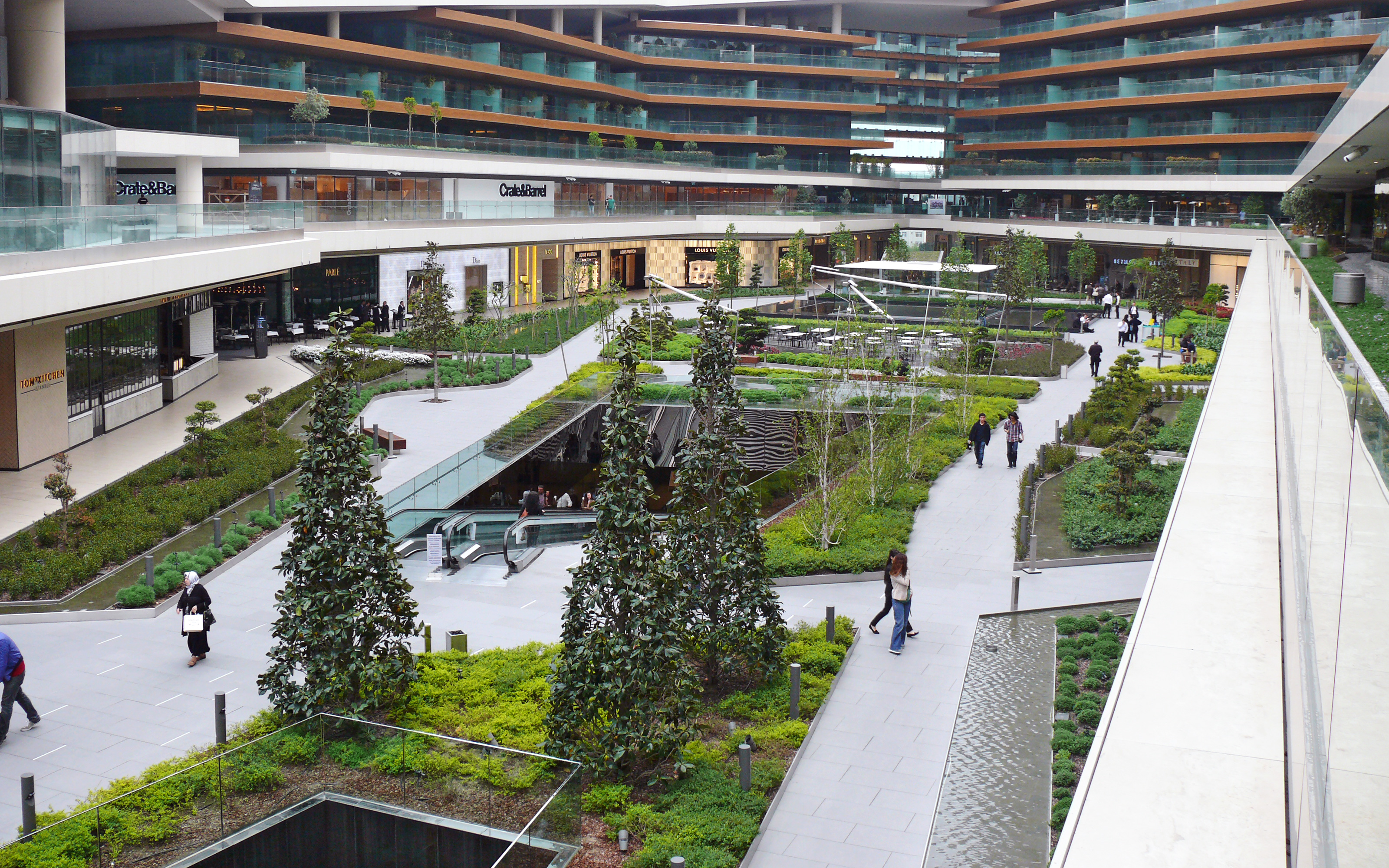 Bird's eye view of the vegetated main square with escalators