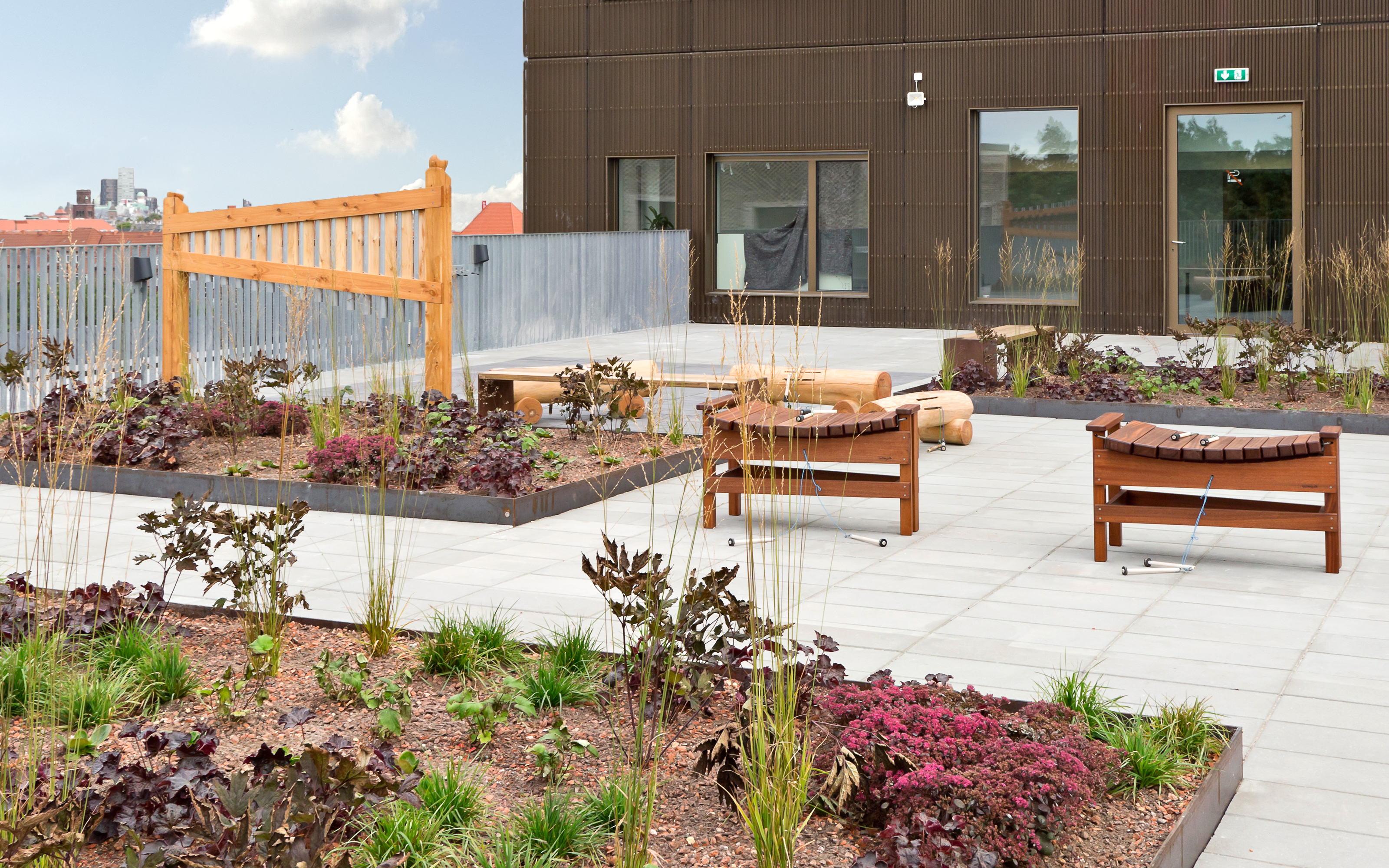 Roof garden with chairs and plant beds