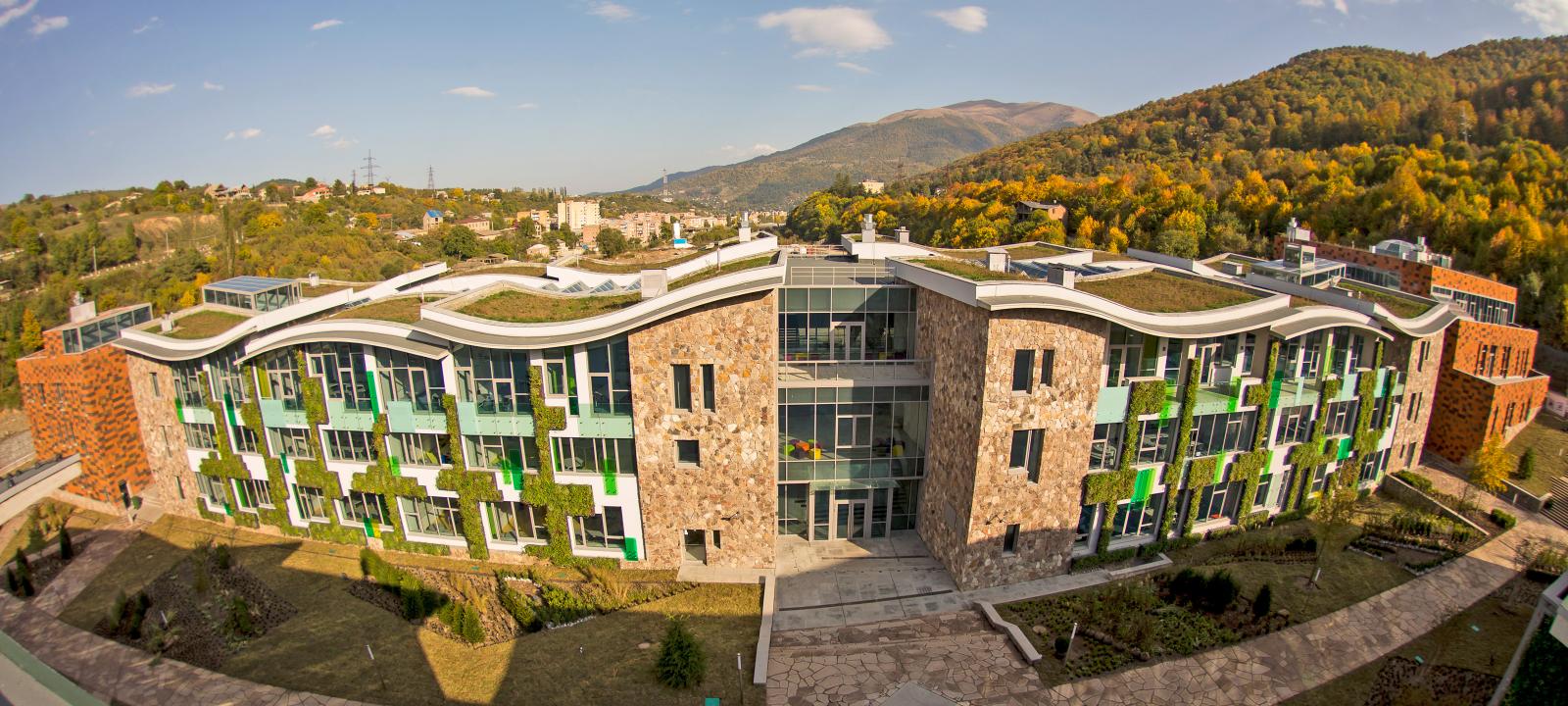 Curved green roof and green facades on a large building