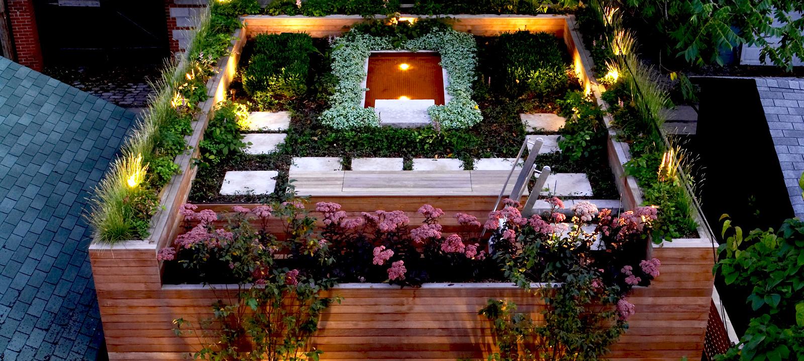 Illuminated roof garden with a pond at night