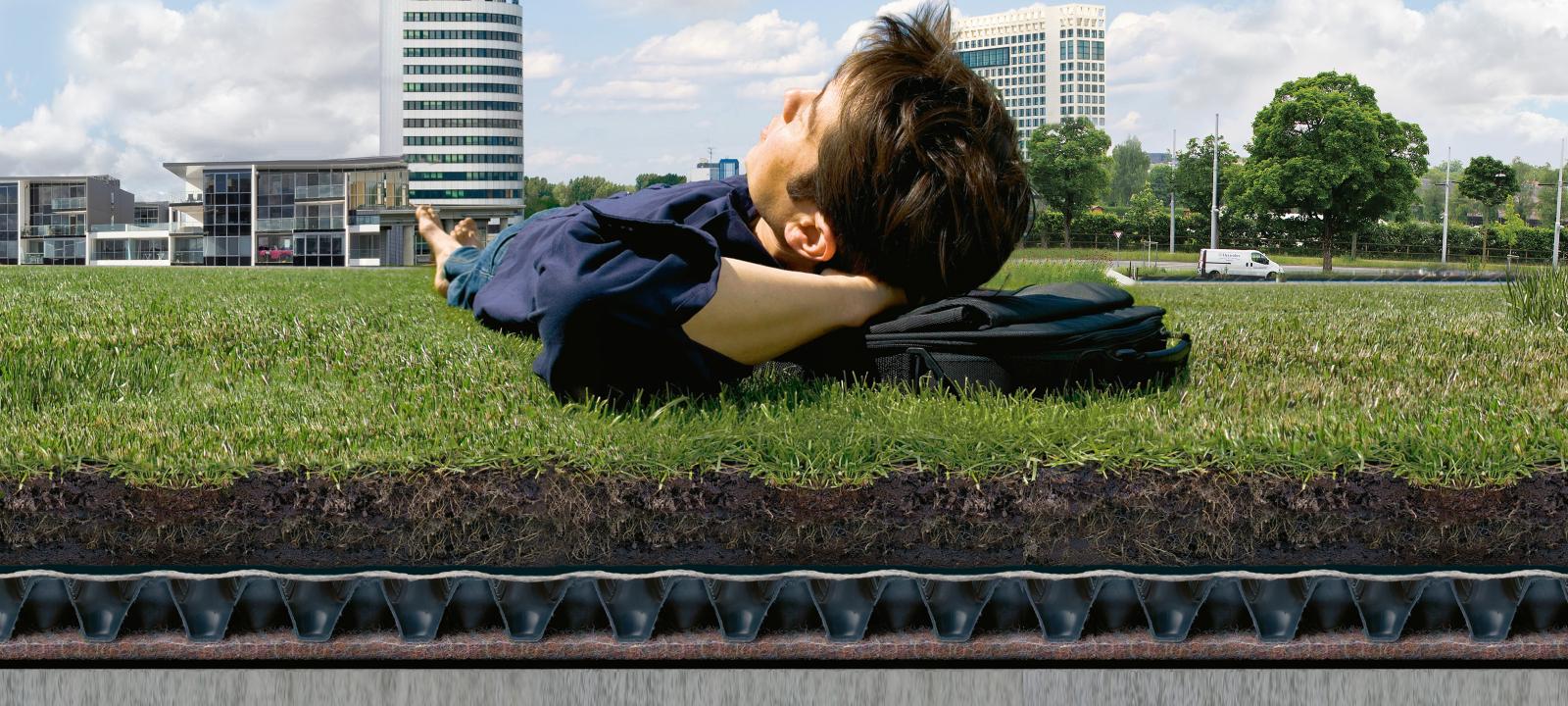 Man lying on green roof system build-up