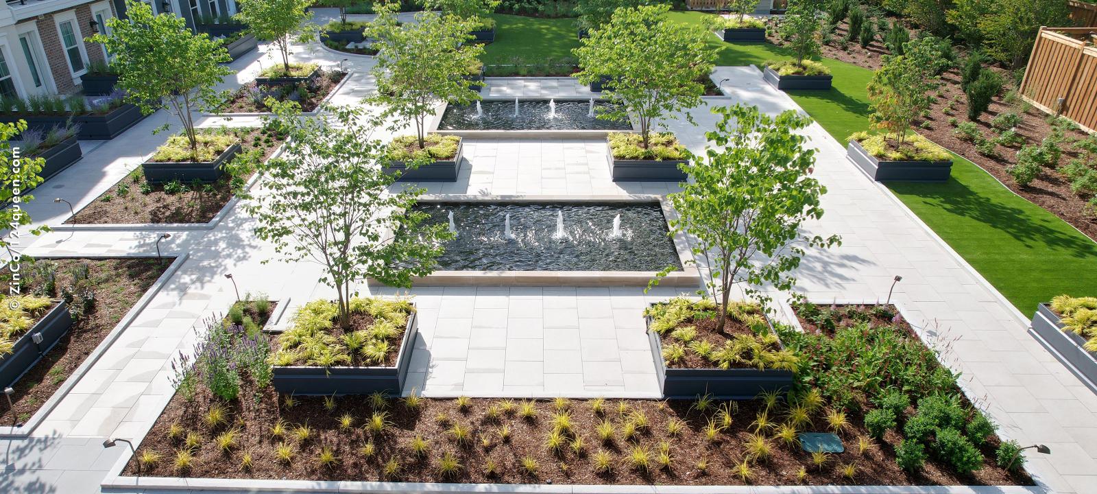 Garden with walkways, water features, lawn, plant beds and small trees