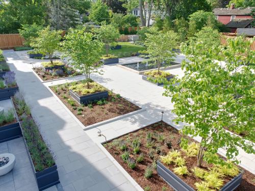 Garden with walkways, plant beds, fire pits and small trees