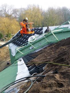 Materials for the green roof system build-up are lifted onto the roof