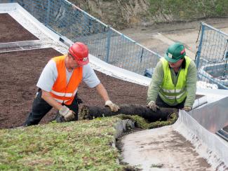 The vegetation mats are trimmed to fit the edging area