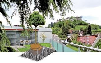 With the new ZinCo Robafix®, trees can be securely fixed on roofs without damaging the waterproofing. Roof garden with lawn and trees
