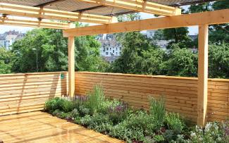 Combination with an intensive green roof Wooden pergola with PV tubes