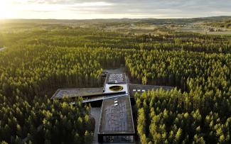 Bird's eye view onto a building surround by wood