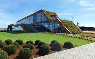 Modern building with glass facades and a green roof