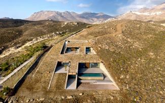 Building that fits seamlessly into the hillside