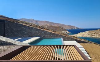 Swimming pool, wooden slats and stone walls