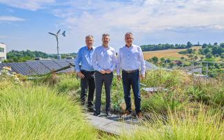 Three persons on a green roof