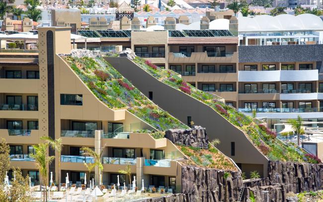 Hotel building with two steep pitched green roofs