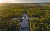 Factory with a green roof and solar surrounded by wood